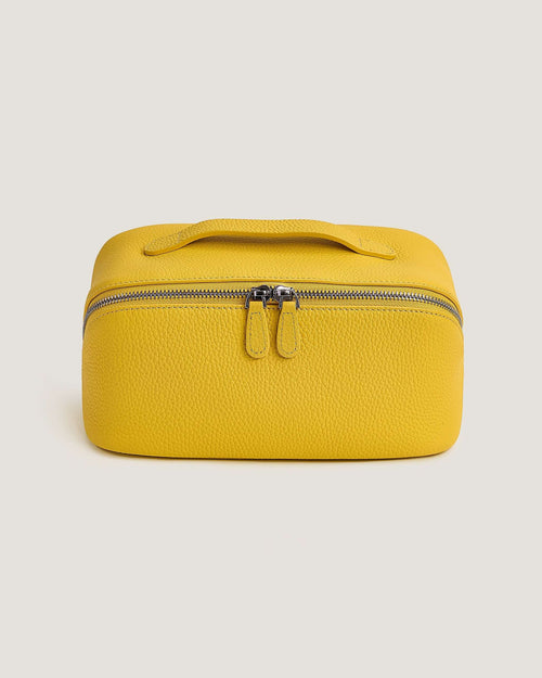 Leather layflat vanity bag in vibrant yellow with zip-around closure and durable handle.