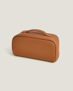 layflat vanity bag in brown leather with a handle, showcasing a sleek and functional design for cosmetics and toiletries.