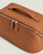LayFlat Vanity Bag made from full grain leather with metal zip-around closure.