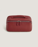 LayFlat Vanity Bag made of full grain leather in a rich red color with zip-around closure and handle.