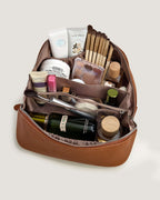 Interior view of layflat vanity bag filled with cosmetics and skincare products, showcasing organizational features.