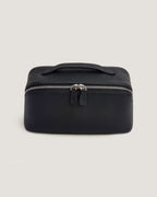 LayFlat vanity bag in black full grain leather with metal zip-around closure and top handle.