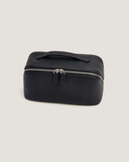 LayFlat Vanity Bag in black leather with zip-around closure and handle