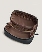 Interior view of a layflat vanity bag showing multiple pockets and a spacious compartment.