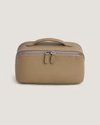 LayFlat vanity bag made of full grain leather in taupe with zip-around closure and handle.