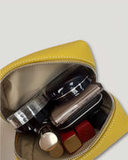 InsideTote Mini Pouch filled with cosmetics, showcasing the leather mini pouch's compact design and functionality.
