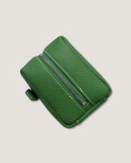 Mini leather pouch in vibrant green with zip closure and textured finish, ideal for organized storage.