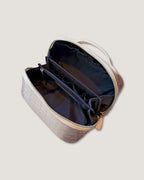 Interior view of LayFlat leather vanity bag showcasing zippered pocket and open compartments.