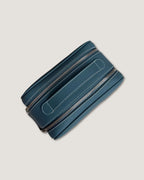 Leather makeup bag in teal color with double-zippers and smooth finish for easy access.