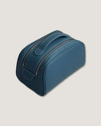 Stylish leather makeup bag in sleek blue with double zipper design for easy access and storage.