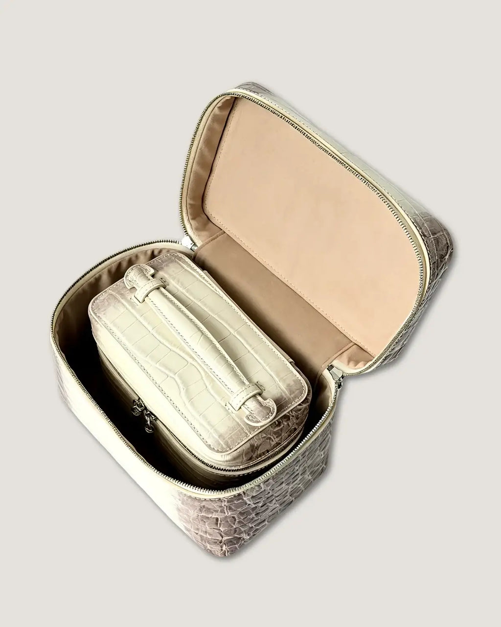 Large leather train case open showing inner compartments and small bag inside, featuring premium top-grain cowhide.