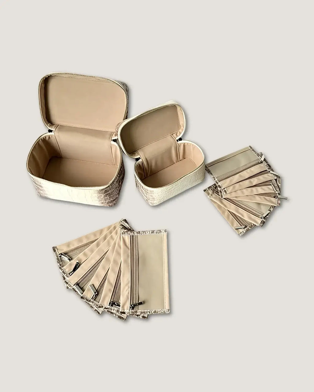 large leather train case and small case with multiple organizers, showcasing premium design and interior velvet fabric.