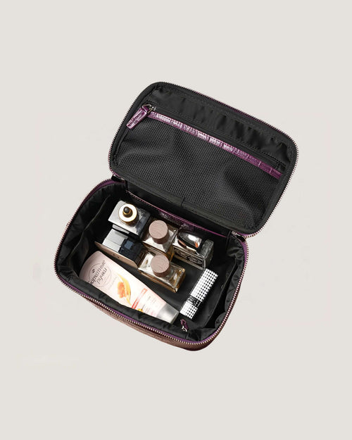 Medium leather train case open showing bottles and skincare inside.