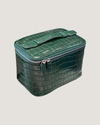 Medium train case leather in green crocodile pattern with a zip-around closure and flat top handle