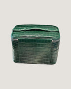 Medium Train Case leather in green crocodile pattern with top handle and zip-around closure.