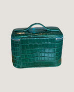 Medium Train Case leather in green crocodile pattern with top handle and zip-around closure.