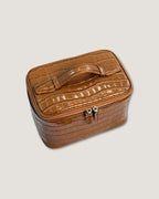 Medium Train Case in a stylish brown crocodile pattern with a zip-around closure and flat top handle.