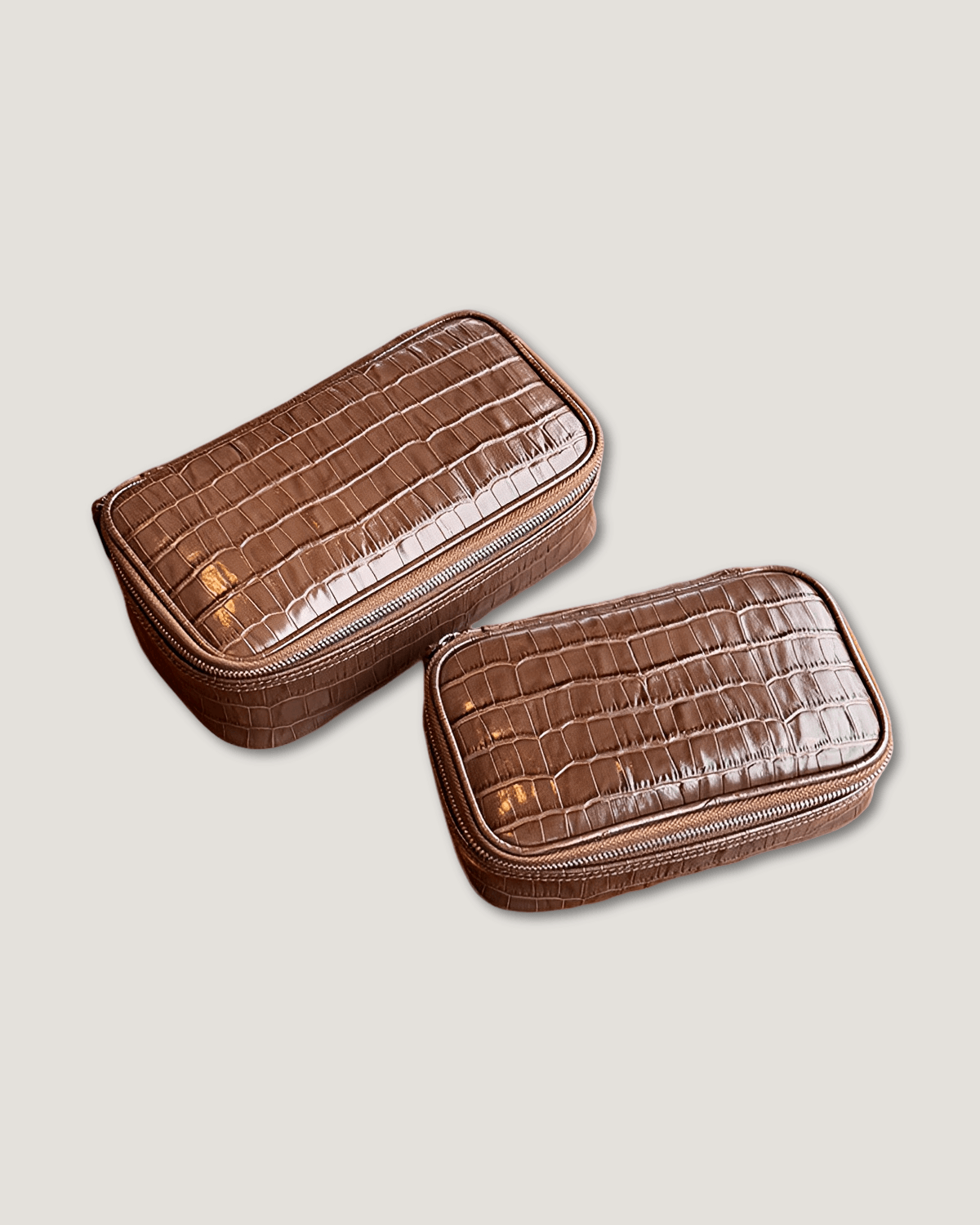 large rectangular leather makeup bag in crocodile patterned brown with zippered closures, ideal for organizing cosmetics.