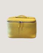 Medium leather vanity bag in bright yellow color with zip-around closure and top handle.