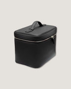 medium leather vanity bag in black, featuring a zippered closure and top handle, perfect for organizing cosmetics.