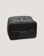 Medium leather vanity bag in black full grain leather with zip-around closure and flat handle.