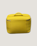 medium leather vanity bag in bright yellow with zip-around closure and flat top handle.