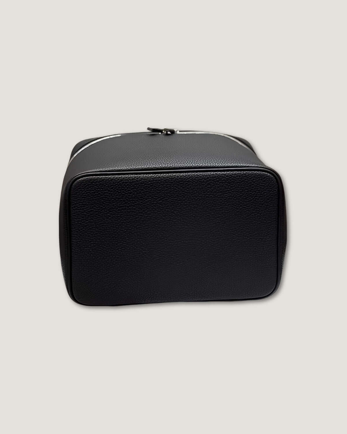 Medium leather vanity bag in black with a sleek, smooth finish and metal zip-around closure.