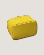 Medium leather vanity bag in vibrant yellow color, featuring a zip closure and textured surface.
