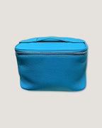 Medium leather vanity bag in bright blue with a zip-around closure and top handle.