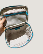 Medium leather vanity bag interior showing zippered and open pockets with a water-resistant lining.