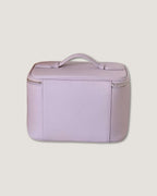 Medium leather vanity bag in lavender color with zip-around closure and top handle.