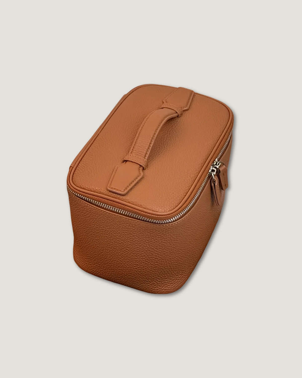 Medium leather vanity bag in tan color with zip-around closure and flat handle.