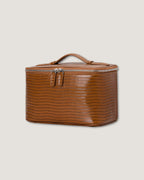 Stylish leather train case in glossy brown with zip closure and flat handle, perfect for travel and organization.