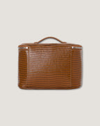 Leather train case in a rich brown color featuring a textured finish and a convenient top handle.