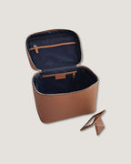 XL leather train case open to show interior pockets and compartments, made from full grain leather.