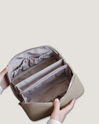 Interior view of a LayFlat Vanity Bag showing multiple compartments and pockets for organized storage.