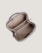 Interior view of the LayFlat leather vanity bag showing zippered pockets and compartments.